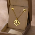 Macro shot of gold heart-shaped necklace and stud earrings set in a premium gift box - Double Heart Hollow (TZ-406)