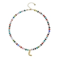 Detail of bohemian necklace with colorful beads and golden bubble letter L pendant - Letter L