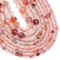 Macro shot of faceted red natural crystal beads with unique mineral textures and inclusions - Red Hematoid Quartz