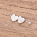 Close-up of heart-shaped freshwater shell bead with golden letter A and pearl detail - Letter A