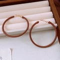 Macro detail of brown leather wrapped hoop earrings with golden clasp in a velvet box - 33# Dark Brown Leather Wrap Large Hoop