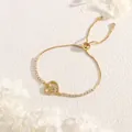 Detail of adjustable gold-plated heart bracelet with sparkling zircon stones and hand charm - Hollow Heart Hand Style