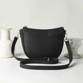 Elegant black pebble leather saddle bag with silver hardware and adjustable strap - Black