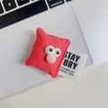 Cute pink plush doll phone grip with big cartoon eyes on a white laptop surface - Pillow Face / Rose Red
