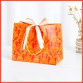 Elegant red paper gift bag with gold damascus patterns and cream satin bow handle - Red (Gold Ribbon)