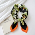 Elegant 70cm silk scarf with green lily pads and orange trim in a necktie knot - Green Lotus Leaf
