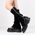 Detail of black knitted leg warmers with metallic zipper on model in studio - One Size / Black