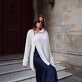 Chic white knit cardigan with side zipper and blue satin skirt on a model in street style - S / White