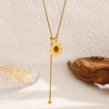 Macro detail of golden sunflower tiger eye necklace with snake chain and tassel pendant - Round Retro Texture Style (12285)