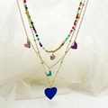 Close-up of multilayered gold chains with colorful heart pendants and vibrant seed beads - Colorful Heart Star Necklace / Colorful