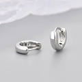 Close-up of high-polished silver huggie hoop earrings with a secure hinge closure - Polished Smooth Style / Small / White Gold