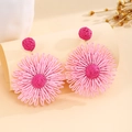 Detailed view of handmade raffia woven flower earrings in pink and rose red colors - Pink
