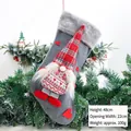 Large 48cm grey Christmas stocking with plush gnome and red heart patch hanging on pine branches - Plush Large Stocking Faceless Braid Gnome