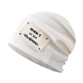 Detailed close-up of cream knit beanie with vintage fabric patch and ribbed texture - White