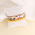 Close-up of bohemian beaded bracelet set on a white cushion with yellow and colorful beads - 6#Mixed Yellow