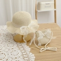 Close-up of beach straw hat and crossbody bag set with lace bows and pearl accents - Beige Hat + Bag