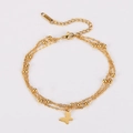 Close-up of gold layered bracelet featuring butterfly charms and delicate metal beads - Gold
