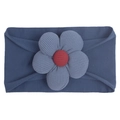 Detail of navy blue knitted baby headband featuring a textured floral design with red center - Navy Blue