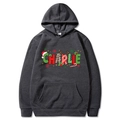 Dark grey Christmas hoodie with festive Charlie print and holiday graphics in flat lay style - Dark Gray