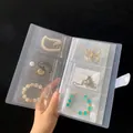 Transparent PVC jewelry organizer book with multiple slots and a snap button closure - Buttoned Style (Small)