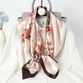 Detail of champagne pink floral silk square scarf tied elegantly on a white blouse - Snow Bud Floral