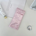 Close-up of pink satin bow quilted glasses pouch featuring a heart-shaped snap button - Small Bow Pink