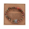 Handmade stone bead bracelet with silver butterfly charm on decorative kraft card - Red Green Spotted Butterfly Bracelet
