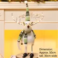 Staande kerstrendier pluche met LED-verlichting op ski's, 50cm feestelijk decor - Zwaaiend Gloeiend Groen (Vrouw)