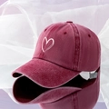 Detailed close-up of a washed burgundy baseball cap with a pink heart embroidery on a mirror - One Size (57-59cm) / Burgundy