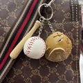 Detailed view of mini baseball keychain set with bat and glove on a handbag - 3.5CM White Ball Khaki
