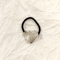 Silver hollow heart ponytail holder with black elastic band on beige paper - Silver Heart Mesh Texture 3.5cm
