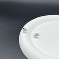 Pair of small minimalist silver flower stud earrings in titanium steel on ceramic tray - Steel Hollow Flower Stud (Single)