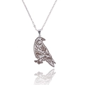 Close-up of silver raven pendant with engraved moon and pumpkin gothic patterns - Silver