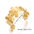 Macro view of gold daisy flower cuff bracelet showing brushed metal texture and 6cm diameter - Flower