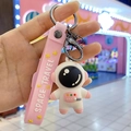 Porte-clés astronaute mignon en silicone rose et blanc avec dragonne Space Travel - Rose