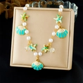 Detail of colorful enamel starfish and shell pendants on a gold-tone beaded necklace - Blue-Green Starfish Shell Style (N3704)