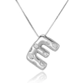 Macro shot of silver letter E necklace pendant with micro-pave cubic zirconia crystals - Letter E