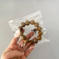 Transparent PVC zip-lock bag for storing a wooden bead bracelet with a Chinese knot - Slider Bag 12*12cm