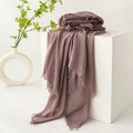 Elegant dusty rose cotton and linen scarf with soft fringes on a white pedestal - Taro Purple