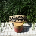 Close-up of beige raffia headband with black floral woven pattern for summer resort - Black and Beige Patchwork Narrow Edge