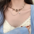 Elegant pearl necklace with a brown flocking bear pendant shown on model neck - Flocked Bear Artificial Pearl Necklace (DX0417) / Coffee