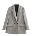Close-up detail of grey double-breasted blazer showing fabric texture and lapel design - Gray