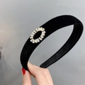 Detail of a black velvet headband with a sparkling round rhinestone buckle decoration - Circle (Oval) Rhinestone Style