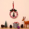 Christmas round ornament with red buffalo plaid, cedar tree, and festive decorations - Round Tree Style