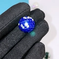 Sparkling blue crystal rhinestone pave ball bead held by fingers for DIY jewelry - 16mm AB Royal Blue Round Bead