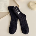 Plush black coral fleece socks featuring three white bows on a cozy light tray - One Size / Black