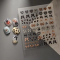 Close-up of 3D embossed leopard and bow nail stickers with sparkling crystal accents - Leopard Heart Bow (CO-139)