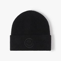 Black ribbed knit beanie with embroidered black smiley face logo for autumn and winter - One Size / Black