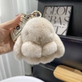 Detail of cream plush bunny keychain with gold ring on a BMW car key, soft fur texture - 10cm Bunny / Milk Tea