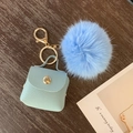 Sky blue fuzzy pompom keychain with a mini mint green lizard textured pouch and gold ring - Crocodile / Blue